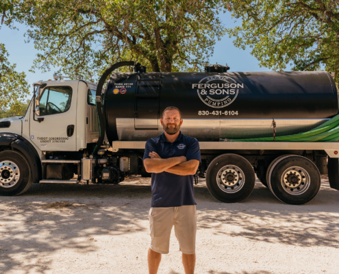 Ferguson & Sons Septic Pumping Employee and Truck