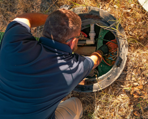 Ferguson & Son Septic Pumping Employee working on a Riser