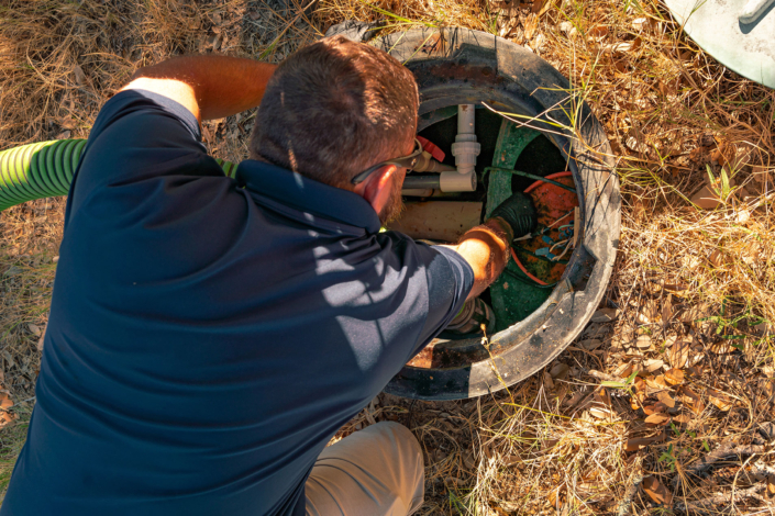 Ferguson & Son Septic Pumping Employee working on a Riser
