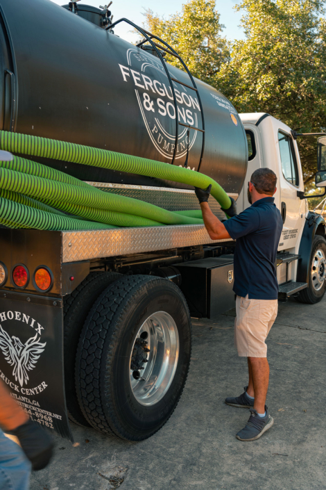 Ferguson & Son Septic Pumping Truck and Employee with Hose